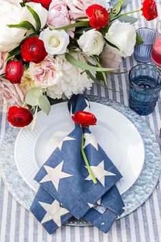 a patriotic table setting with red, white and blue flowers