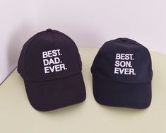 two baseball caps with the words best dad ever on them sitting next to each other