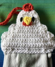 a crocheted chicken hat hanging from a hook