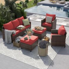 an outdoor living room with red and brown furniture next to a swimming pool in the background