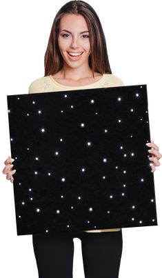 a woman holding up a black board with stars on it