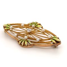 FREE shipping on all orders! FREE 5 Day Returns! Learn More. Part of our Vintage Collection, a spectacular American Art Nouveau Krementz brooch. The 14K yellow gold brooch features a filigree oval setting with green enameled leaves dotted with seed pearls. A prong set old European cut diamond adorns the center. Brooch or Pin Closure Type: C Clasp with Safety Clasp Hallmark: 14K and Krementz Trademark Designer: Krementz Era: Art Nouveau Total Weight: 2.80 dwt Center Diamond: (1) Old European Cut, Heirloom Style Oval Filigree Brooch, Heirloom Filigree Oval Brooch, Heirloom Oval Filigree Brooch, Elegant Green Filigree Brooches, Formal Green Enamel Brooches, Elegant Green Oval Brooches, Green Art Nouveau Wedding Brooches, Art Deco Oval Brooch For Anniversary, Oval Green Brooch Jewelry