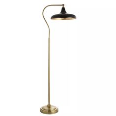 an antique brass floor lamp with a black shade