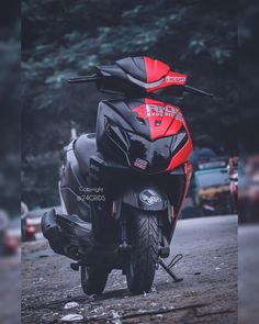 a red and black motorcycle parked on the street