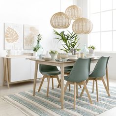 a dining room table with chairs and plants on the top, in front of a large window