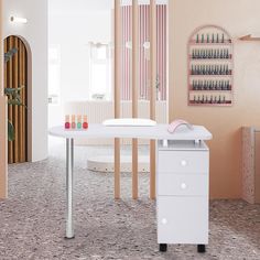 a white table sitting in the middle of a room next to a wall with bottles on it