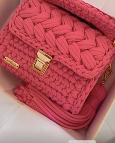 a pink handbag in a white box