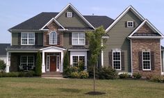 a large house in the middle of a grassy area