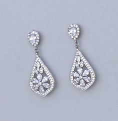 "Elegant and classical 'modern' vintage! Gorgeous rhodium cubic zirconium earrings in a filigree design have the same sensational sparkle as real diamonds. Designed in a style that enhances most facial shapes, you'll find them perfect if you are wanting a sophisticated earring for your wedding day jewels. ★★ We now also make these in clip ons that look identical. Length : approx 1.25\" (3 cm) Set in tarnish resistant 16K rhodium (aka white gold) plate with a nickel free earpost. ★Shopping for yo Formal Bridal Earrings With Cubic Zirconia, Formal Cubic Zirconia Bridal Earrings, Cubic Zirconia Bridal Drop Earrings, Silver Earrings With Intricate Diamond Design, Classic Cubic Zirconia Chandelier Earrings With Elegant Design, Elegant Filigree Earrings In Cubic Zirconia, Classic Cubic Zirconia Chandelier Earrings, Wedding Crystal Earrings With Pierced Cubic Zirconia, Pierced Crystal Cubic Zirconia Earrings For Wedding