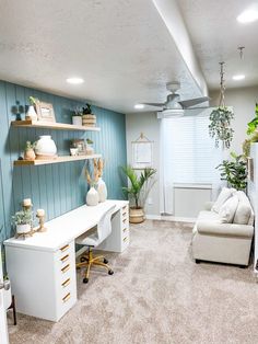 a living room filled with furniture and lots of plants