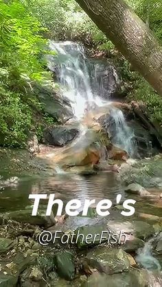 there's a waterfall in the middle of some rocks and trees with water running down it