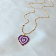 Don't miss out on this beautiful gold plated and purple retro heart necklace. They work with a large variety of looks and add a bit of sparkle to your outfit. MORE jewellery pieces avaliable on our shop! Any questions please message we are happy to help. Free postage in UK Thank you for shopping with us Heather&Bumble 📪Follow us at: Instagram: heatherandbumble Twitter: Heather_Bumble Pintrest: Heather & Bumble Purple & Gold Retro Heart Necklace -  70's Style Necklace, Vintage Style, Hanging Jewellery, Accessories, Purple Jewellery, Gold Necklace Jewellery Gold Necklace, Purple Jewellery, 90s Necklace, Schmuck Gold, Purple Retro, Retro Heart, Purple Jewelry, Hanging Jewelry, Purple Necklace