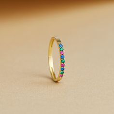 Our rainbow stone half-eternity band ring is an exquisite blend of elegance and vibrancy. Made with precision, this stunning piece is available in sterling silver or the luxurious options of 10k, 14k, or 18k gold. The band features a dazzling array of mixed rainbow stones, each telling a unique story with its burst of color. With 9 carefully arranged stones, this ring is not just a piece of jewelry; it's a celebration of individuality and joy.  Perfect for everyday wear or as a special gift, thi Elegant Stackable Rainbow Ring, Fine Jewelry Birthstone Ring With Half Eternity Band, Elegant Multicolor Gemstone Stackable Rings, Elegant 14k Gold Multi-stone Eternity Band, Elegant Multicolor Multi-stone Stackable Rings, Elegant Multicolor Stackable Eternity Band, Elegant Multi-stone Eternity Band, Elegant Multicolor Stackable Rings For Wedding, Elegant Multicolor Eternity Band As Gift