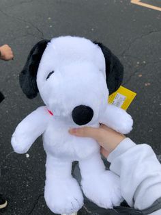 a person holding a stuffed dog in their hand