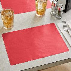 the placemats on the table are red and white