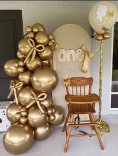 a chair sitting next to a bunch of balloons