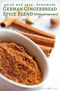 a white bowl filled with cinnamon spice next to cinnamon sticks