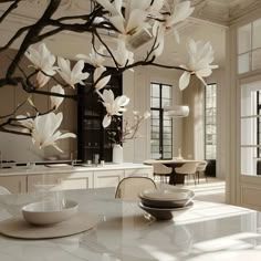 a dining room table with plates and bowls on it