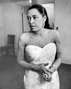 a black and white photo of a woman in a wedding dress