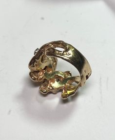 . Very cool poured gold Nugget ring in size 6. Very easy to wear and a nice heavy feel. 3 .05ct round brilliant cut diamonds. Circa 1985. 9.13 grams 14 karat yellow gold 0.15 carats I-J SI round brilliant cut diamonds Size 6 Unique Collectible Diamond Rings, Elegant Nugget Diamond Ring For Anniversary, Unique Gold Ring With Prong Setting, Unique Gold Round Cut Diamond Ring, Unique Gold Diamond Ring With Round Cut, Unique Gold Diamond Ring With Prong Setting, Unique Gold Rings With Diamond Accents, Gold Nugget Ring, Cz Rings Engagement