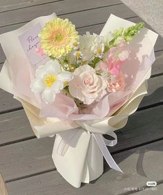 a bouquet of flowers sitting on top of a wooden table