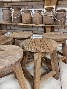 several wooden stools and tables in a room