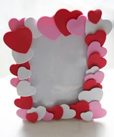 a heart shaped frame sitting on top of a table