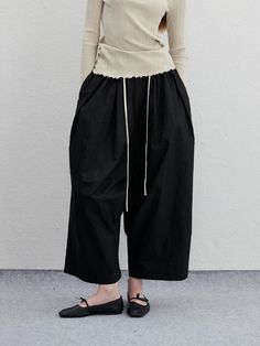 It is a casual wide fit pant made of wrinkle fabric. The pant has pleats on the front that makes perfect wide fit silhouette. The pant has elastic band waist for comfy fit.- Side pockets- Back pockets- Pleats on the front- Wide fit Relaxed Fit Bottoms With Pleated Waist And Wide Leg, Relaxed Fit Wide Leg Bottoms With Pleated Waist, Relaxed Fit Wide Leg Bottoms With Gathered Waist, Wide Leg Bottoms With Folds, Relaxed Fit Wide-leg Pants With Pleated Waist, Wide Leg Bottoms With Folds For Workwear, Spring Wide Leg Pants With Gathered Waist, Chic Wide Leg Bottoms With Folds, Baggy Pleated Wide-leg Pants