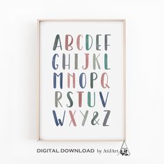 an alphabet poster with the letters in different colors and sizes, hanging on a wall