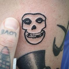 a man with a skull tattoo on his arm