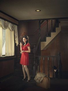 a woman in a red dress holding an umbrella