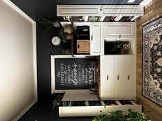 an overhead view of a room with white cabinets and black walls, including a chalkboard