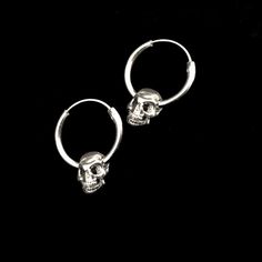 Sterling silver hoop earring has a diameter of 7/8 inch with a .75 inch , hollow , silver plated pewter skull hanging from it. It latches by fitting the wire section back into the hollow hoop. The hoop is 7/8 inch x 2mm thick. The combined pieces measure 1.25 inches. These earrings are SOLD PER PAIR. This piece of jewelry is sent in a bubble pack envelope via US postal service, first class mail,free in the US. International rate is $15. Buyers are responsible for any customs and import taxes tha Edgy Handmade Metal Jewelry, Silver Huggie Single Earring, Edgy Handmade Jewelry Gift, Handmade Edgy Jewelry For Gifts, Handmade Punk Metal Jewelry, Edgy Round Metal Jewelry, Silver Internally Threaded Hoop Earrings, Sterling Silver Internally Threaded Hoop Earrings, Sterling Silver Hoop Earrings Internally Threaded