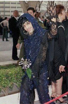 two women in black and one is wearing a blue dress with sequins on it