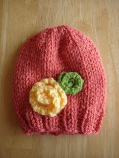 a knitted hat with a crochet flower on it