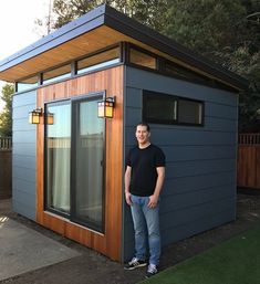 a man standing in front of a tiny house