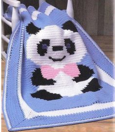 a crocheted blanket with a panda bear on it