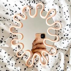 a person taking a selfie in front of a mirror with an octopus ring around it