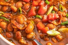 a white bowl filled with stew and vegetables