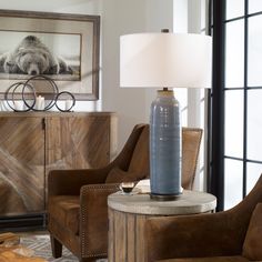 a living room scene with focus on the table lamp and chair in the foreground