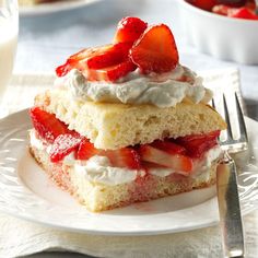 strawberry shortcakes with whipped cream and fresh strawberries on top, ready to be eaten