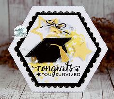 a card with a graduation cap and stars on it, sitting on a wooden table