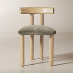 a chair made out of wood with a grey seat and back cushion on the side