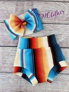 Orange/ Blue Serape Stripe High Waisted Bummies/ Baby Girl High Waisted  Shorts/ Bummies and Headwrap Bow Set Cute Blue Summer Bloomers, Cute Blue Diaper Cover For Playtime, Cute Multicolor Bottoms For Playtime, Cute Multicolor Beach Bottoms, Bummies Outfit, Woman Costumes, Baby Loading, Wholesale Boutique Clothing, Western Baby