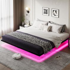 a bed with pink lights on it in a room