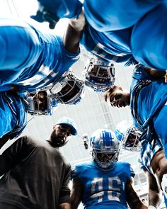 a group of football players standing in a huddle