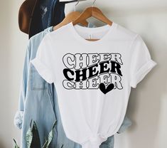 "Welcome to Maddy Paddy Designs Etsy Shop! This listing is for a cheer mom shirt. *If you would like to see the design on a different style shirt, please do not hesitate to ask. I use Bella + Canvas premium t-shirts which have a soft and light feel. They are very comfy and will became your favorite tee to wear. With unisex sizing it's perfect for both men and women. Solid Colors * 100% Cotton Athletic Heather * 90% cotton * 10% polyester Heather * 52% cotton * 48% polyester I suggest that you me Mustang Cheer Shirts, Cheerleading Competition Shirts, Cheer Tees Shirt Ideas, Cheerleader Tshirt Designs Ideas, Mini Cheer Camp Shirts, Cheerleader Shirt Ideas, Short Sleeve Letter Print Shirt For Cheerleading, Team Spirit Cheerleading Tops With Text Print, Cheerleading Text Print Tops With Team Spirit