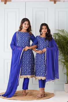 Mother's Salwar Kameez:-Cotton Silk Pakistani Suit in Royal Blue This Readymade Hand Embroidered attire with Cotton Lining is Enhanced with Pocket, Tassels, All Over Mirror, Zari, Cutbeads work along With Fancy Mirror Scalloped Border. Crafted in Round Neck and Quarter Sleeve. Available with an Art Silk Pant with Cotton Lining in Royal Blue and a Gota Lace Work Faux Chiffon Dupatta in Royal Blue. The Kameez and Bottom Lengths are 43 and 36 inches respectively Do note: Accessories shown in the im Festive Blue Sharara With Straight Kurta, Traditional Blue Palazzo Set For Festive Season, Traditional Drape Blue Embroidered Palazzo Set, Blue Sharara With Straight Kurta For Festive Occasions, Traditional Blue Palazzo Set For Festive Occasions, Festive Blue Unstitched Sharara, Traditional Blue Palazzo Set With Mirror Work, Blue Unstitched Sharara For Festive Occasions, Blue Bollywood Palazzo Set With Dupatta