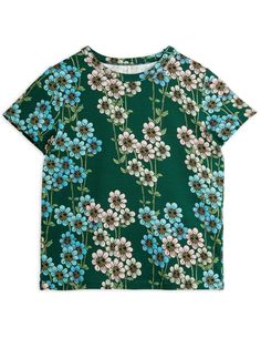 The blouse by Mini Rodini is a cute and stylish choice for warm days. This short-sleeved blouse in a beautiful green colour is decorated with a colourful floral pattern that adds a cheerful and fresh touch. Made from high-quality materials, the blouse is soft and pleasant to the touch, ensuring comfortable wear all day long. It is the perfect wardrobe piece that combines comfort and fashionable design, ideal for any occasion.

Colour: Green
Material: 100% Organic Cotton Green Printed Spring Tops, Green Floral Print Short Sleeve Top, Light Green Short Sleeve Tops For Spring, Dark Green Cotton Top For Spring, Dark Green Cotton Tops For Spring, Cute Printed Green T-shirt, Cute Green Printed T-shirt, Cute Green Printed Top, Green Crew Neck Top With Floral Print