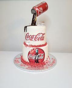 two tier cake with coca cola on top